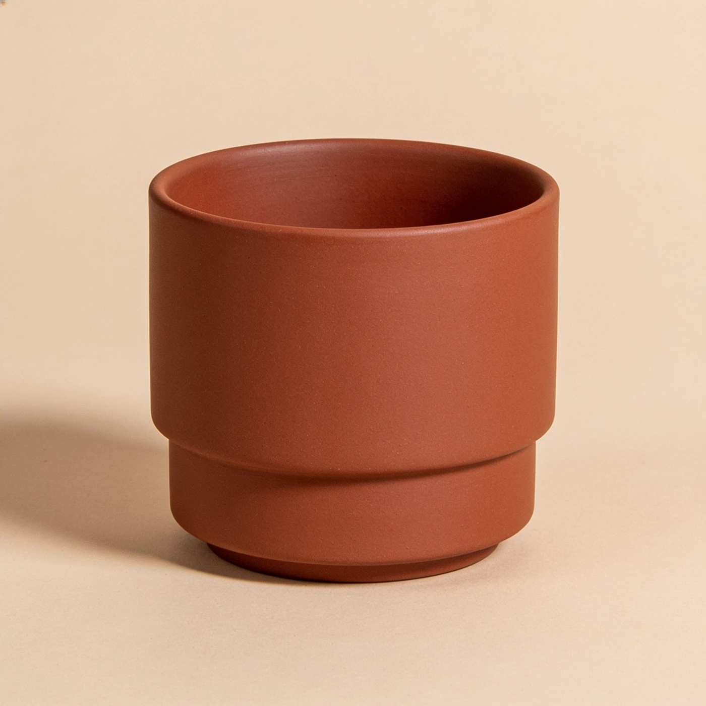 Ledger Stack Mug — matte rust stoneware; straight stackable walls and recessed foot