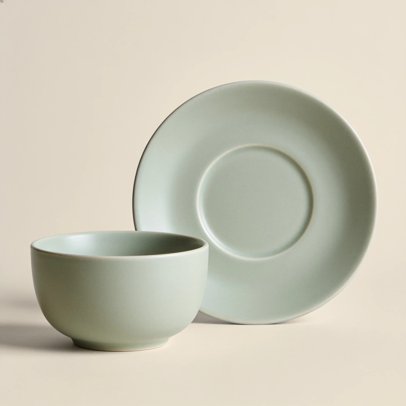 Dawn Saucer Cup — pale sage glazed porcelain; low cup and separate matching saucer
