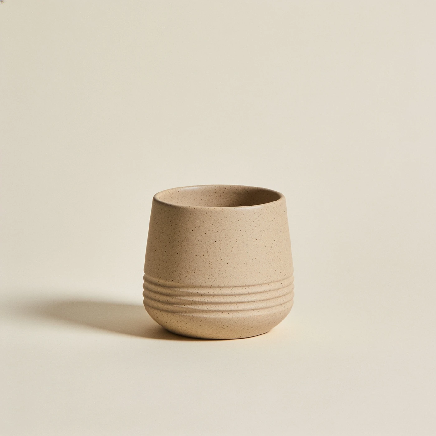 Palm Handleless Cup — speckled sand stoneware; tapered handleless form with shallow grip ribs