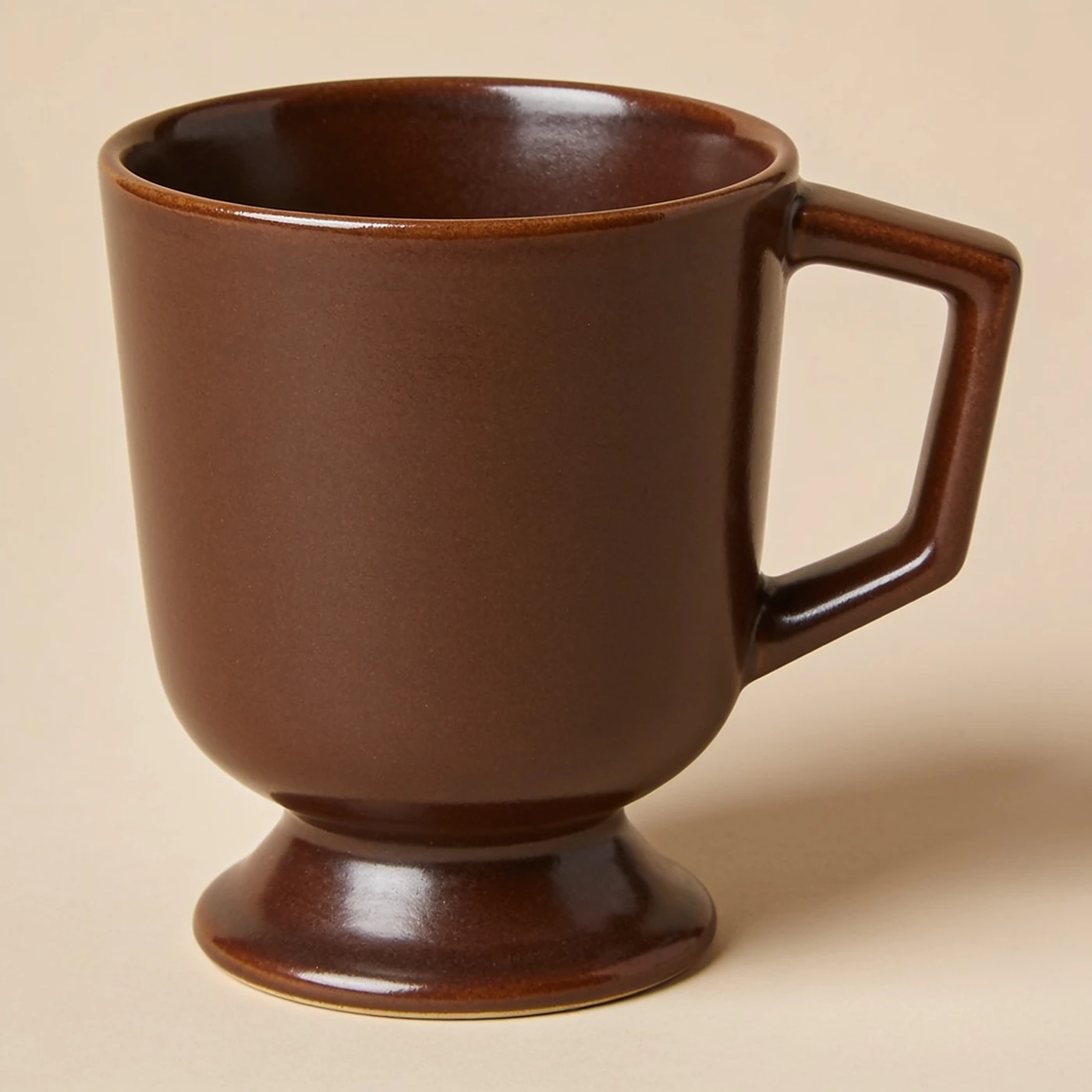 Porch Pedestal Mug — deep brown glazed stoneware; pedestal foot and angular open handle